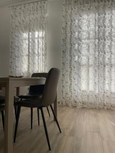 une table à manger avec une chaise et une fenêtre dans l'établissement Salinelle Home, à Paterno