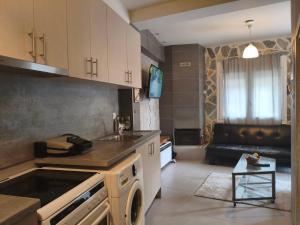 a kitchen with a sink and a stove top oven at peramalux in Ioannina