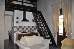 a living room with a white couch and a staircase at Casa de las Remigias in Estepona