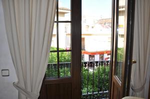 a door to a balcony with a view of a building at Casa de las Remigias in Estepona