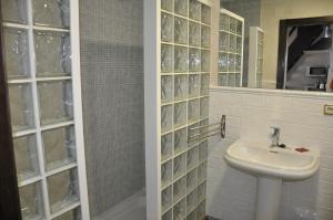 a bathroom with a sink and a glass wall at Casa de las Remigias in Estepona