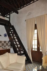 a living room with a white couch and a staircase at Casa de las Remigias in Estepona