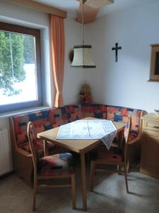 a dining room with a table and a couch at Haus Pranger in Gschnitz