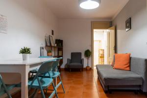 a living room with a couch and a table and chairs at WOT New Lisbon Social in Lisbon