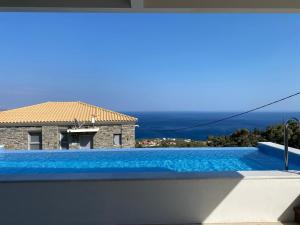 een zwembad met uitzicht op een huis bij Villa Dolihi in Agios Kirykos