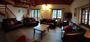 a living room with couches and a coffee table at Chalet Huwi Zermatt in Zermatt