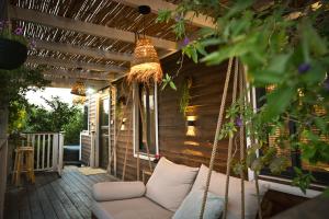 a porch with a hammock on a house at בקתת שקד Shaked Cabin in Natur