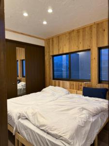 a large white bed in a room with two windows at Kamakura in Iiyama +25 photos