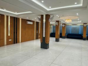 a lobby with columns in a building at MG Plaza Hotel in Jodhpur