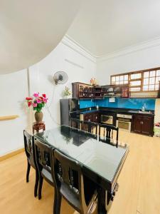 a dining room with a glass table and chairs at SAM HOUSE 2 Huế in Cồn Giả Viên