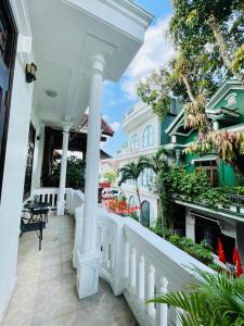 a white porch of a house with a white railing at SAM HOUSE 2 Huế in Cồn Giả Viên