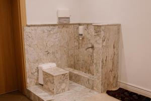 a marble bathroom with a shower and a toilet at Pana Unique Semey in Semey +93 photos