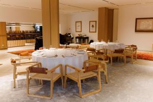 a group of tables and chairs in a room at Pana Unique Semey in Semey