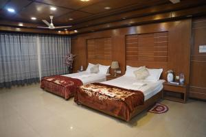 Postel nebo postele na pokoji v ubytování Ali International Hotel