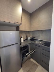 a kitchen with a stainless steel refrigerator and a sink at Dukk in Belgrade +8 photos