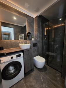 a bathroom with a washing machine and a sink at Dukk in Belgrade