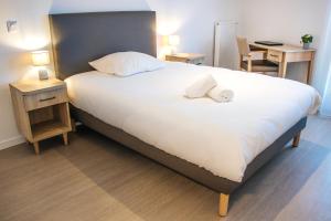 Postel nebo postele na pokoji v ubytování Résidence Nouvelles Sylphides Carrières-sous-Poissy