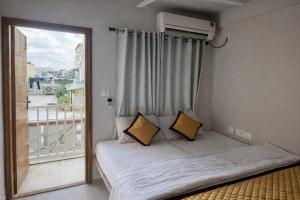 a small bedroom with a bed and a window at Nova Regency in Bangalore