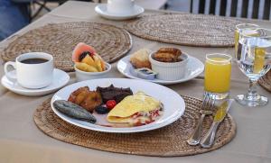 a table with a plate of breakfast food and a cup of coffee at San Gregorio Hotel & SPA in Villa Canales