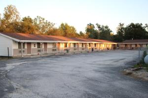 an empty parking lot in front of a building at Frontier Motel in Kingdom City