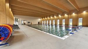 a large swimming pool in a large building at Apartmány pri Belej in Liptovský Hrádok