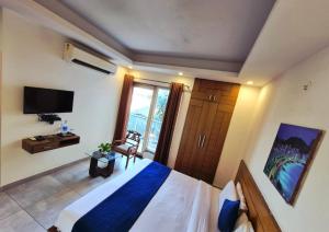 a bedroom with a bed and a large window at Stays - NH 8 in Gurgaon