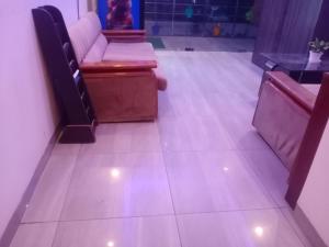 a waiting room with benches and a tiled floor at Stays - NH 8 in Gurgaon