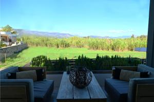 a patio with a table and a view of a field at Hydra House Nafplio in Myloi