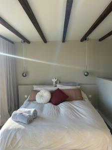 a bedroom with a large white bed with pillows at Studio34 in Hauwert