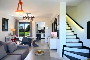 a living room with a couch and a staircase at Hydra House Nafplio in Myloi