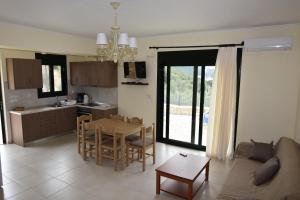 a kitchen and living room with a couch and a table at Sivota Apartments in Syvota