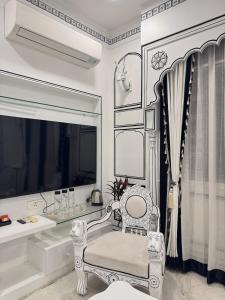 een witte kamer met een stoel en een spiegel bij Lalluji Luxe in Jaipur