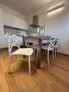 a dining room with a table and chairs in a kitchen at Mugello Circuit & Florence charm in Scarperia