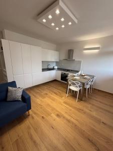 a living room with a table and chairs and a kitchen at Mugello Circuit & Florence charm in Scarperia