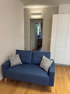 a blue couch sitting in a living room at Mugello Circuit & Florence charm in Scarperia +25 photos