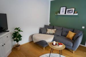a living room with a couch and a table at Bergnest Fieberbrunn in Fieberbrunn