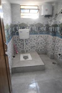 een badkamer met toilet in een kamer bij Laxmi Narasimha hotel in mayapur