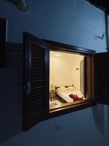 a view of a bedroom through a window at MERIT Guest House in Aswan