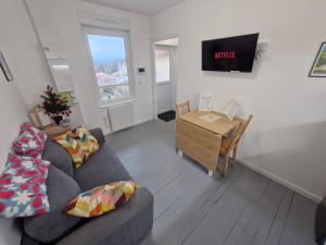 ein Wohnzimmer mit Sofa und Tisch in der Unterkunft Appartement F2 5B in Martres-de-Veyre