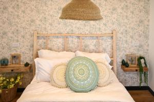 a bedroom with a bed with a pillow on it at בקתת שקד Shaked Cabin in Natur +24 photos