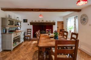 a kitchen and dining room with a wooden table and chairs at 5 Bed in Hindolveston oc-d29357 in Hindolveston