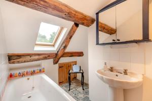 a bathroom with a tub and a sink and a mirror at 5 Bed in Hindolveston oc-d29357 in Hindolveston +24 photos