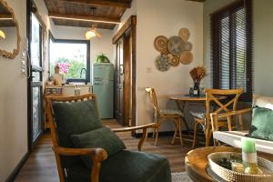a kitchen and living room with a table and chairs at בקתת שקד Shaked Cabin in Natur