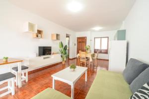 a living room with a couch and a table at CHL Serycam Breña Baja, infinity views in Breña Baja
