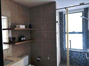 a bathroom with a shower and a toilet and a sink at The Lume Studio - Tresor D4 in Ho Chi Minh City
