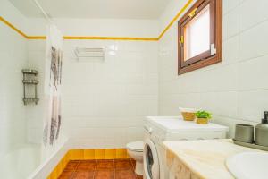 a bathroom with a toilet and a sink and a washing machine at CHL Serycam Breña Baja, infinity views in Breña Baja +22 photos