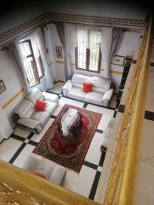 En eller flere senge i et værelse på Maison Blanche Biteng