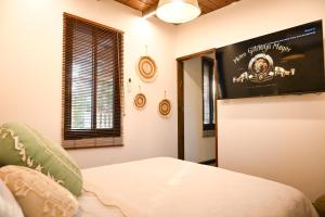 a room with a bed with a poster on the wall at בקתת שקד Shaked Cabin in Natur