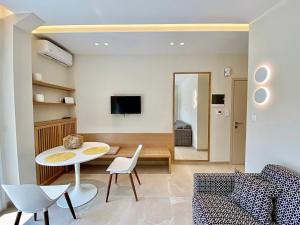 a living room with a table and chairs at Venice Studios & Apartments in Stavros