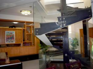 a spiral staircase in a restaurant with a dining room at Villa Les Ambassades in Kenitra +27 photos